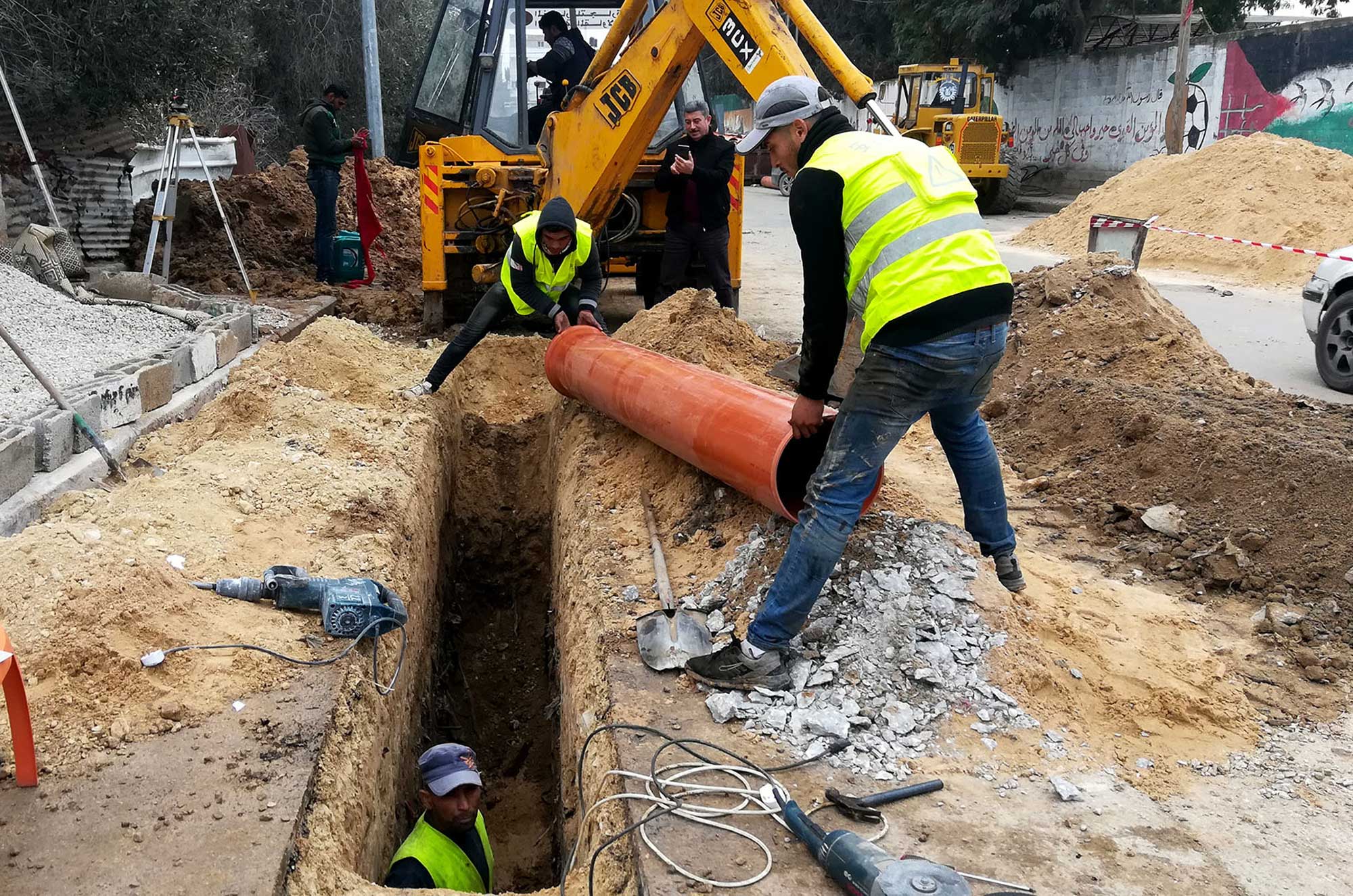 Workers installing storm-water drainage pipes in Beit Hanoun.