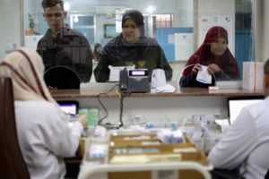 Patients line up to pick up prescriptions from the UNRWA clinic.