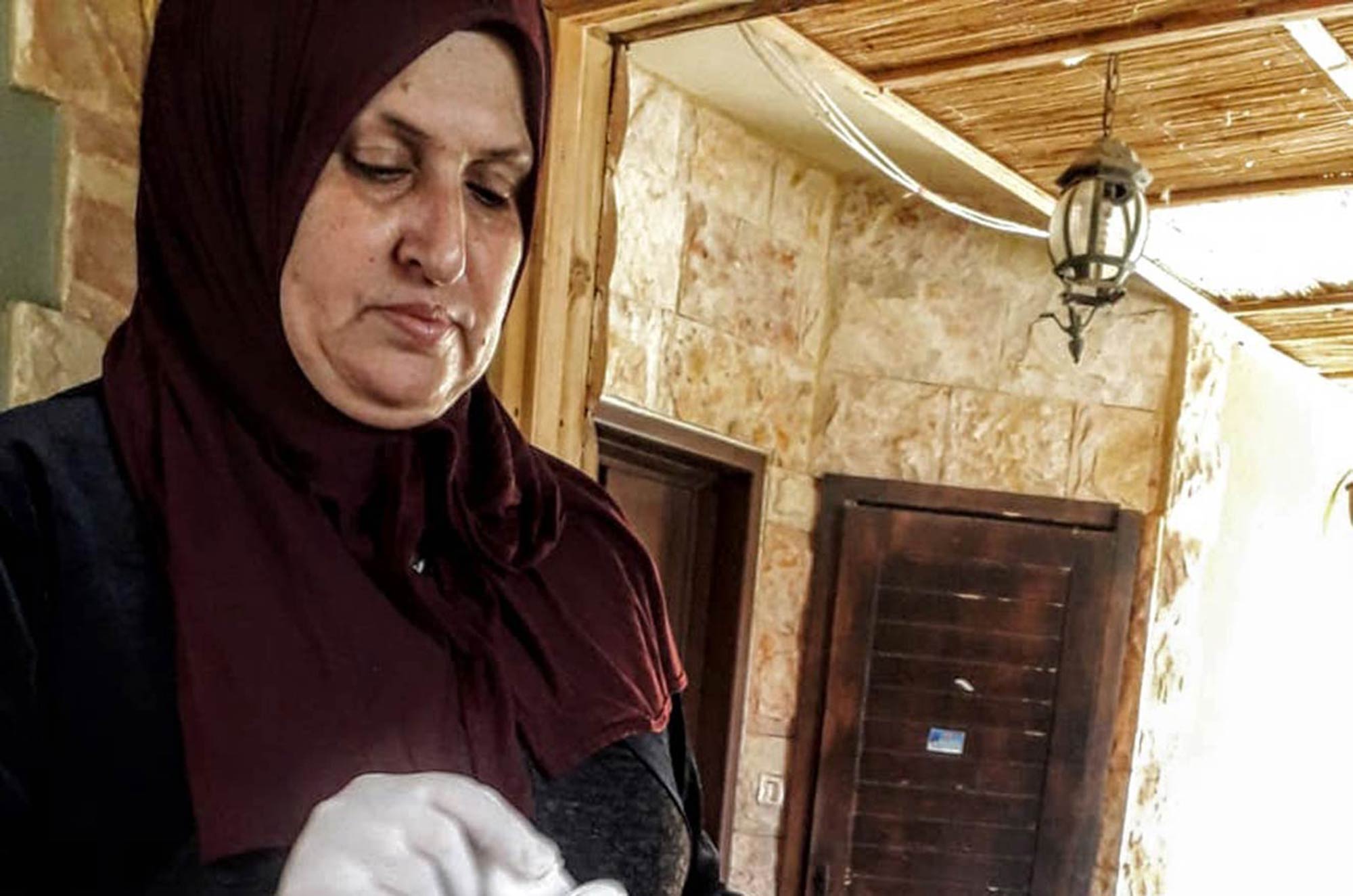 Closeup of Nadera grinding chickpeas for falafel.