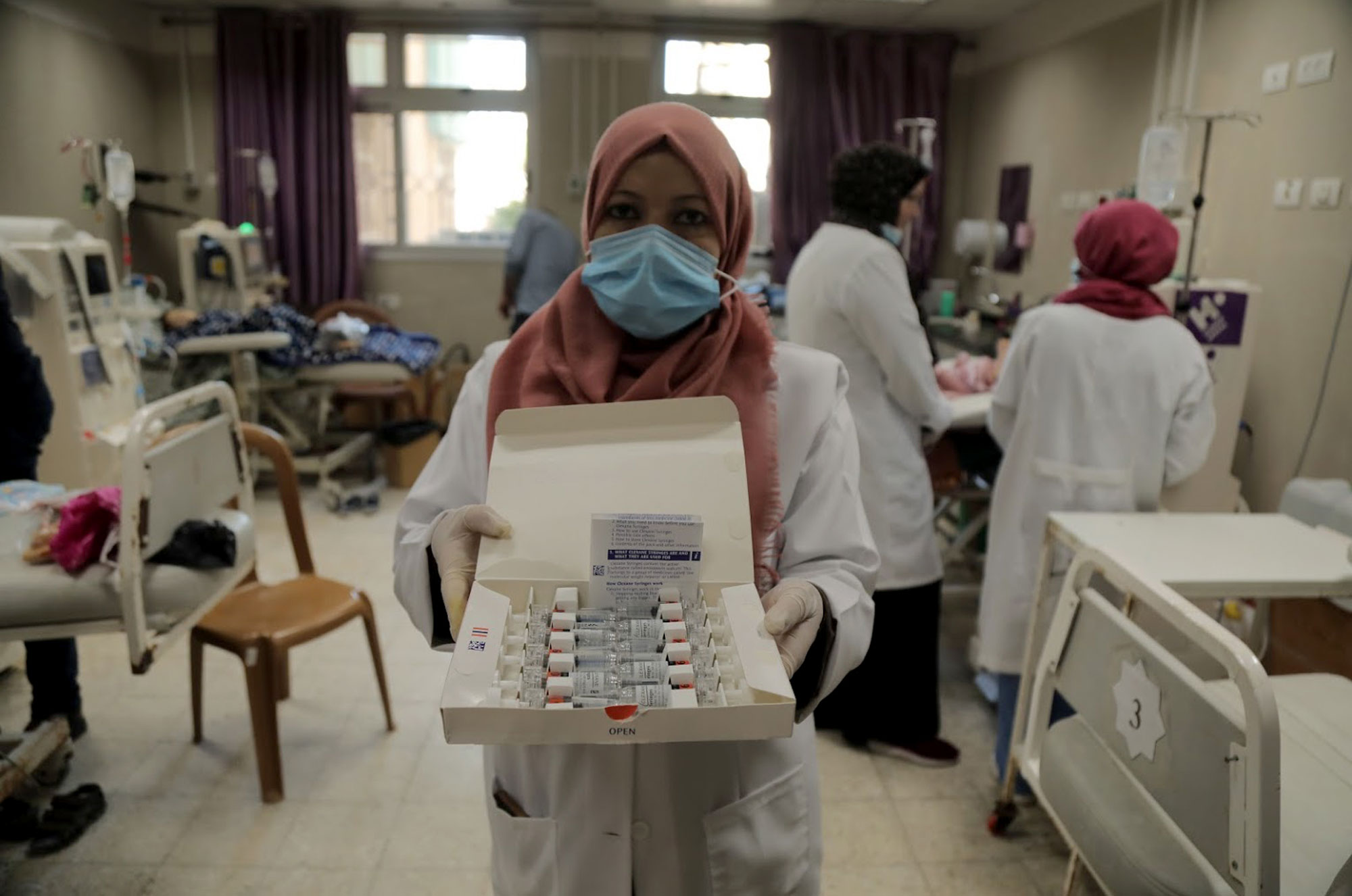 A nurse inside the children’s dialysis unit holds vials of the donated enoxaparin.