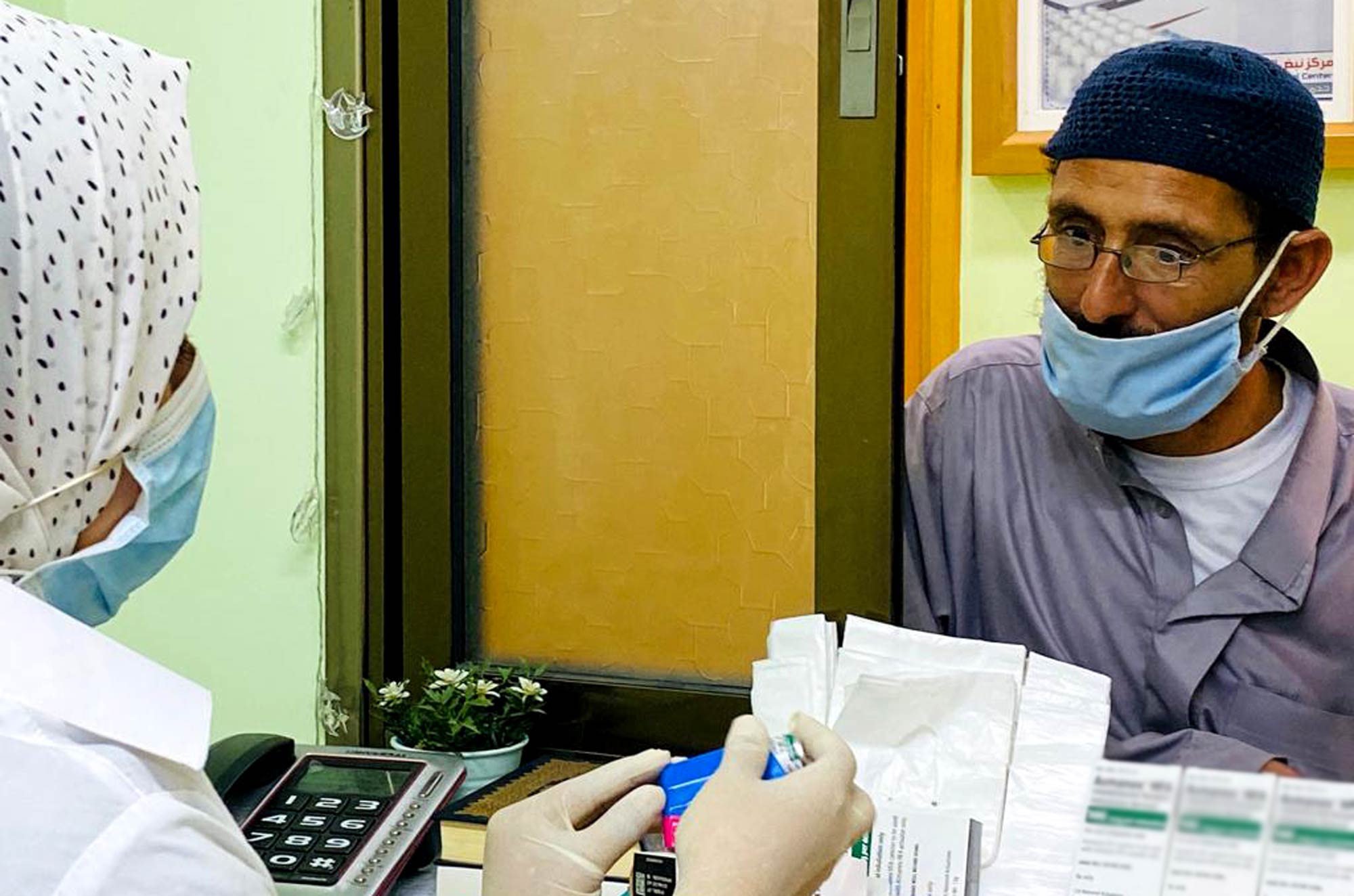 Abedelminin at the pharmacy window in the clinic.