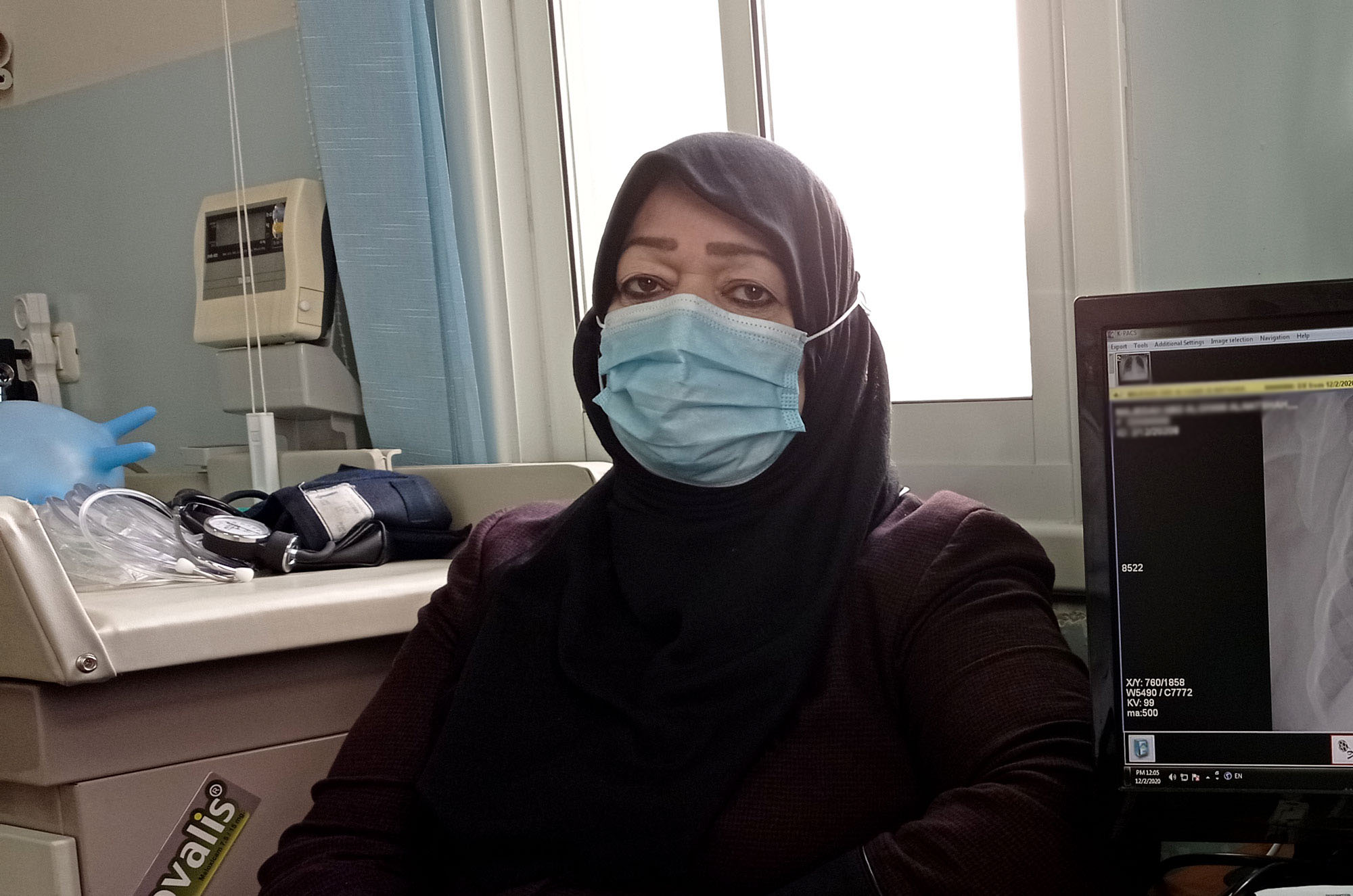 Majeda meets with her doctor at the clinic