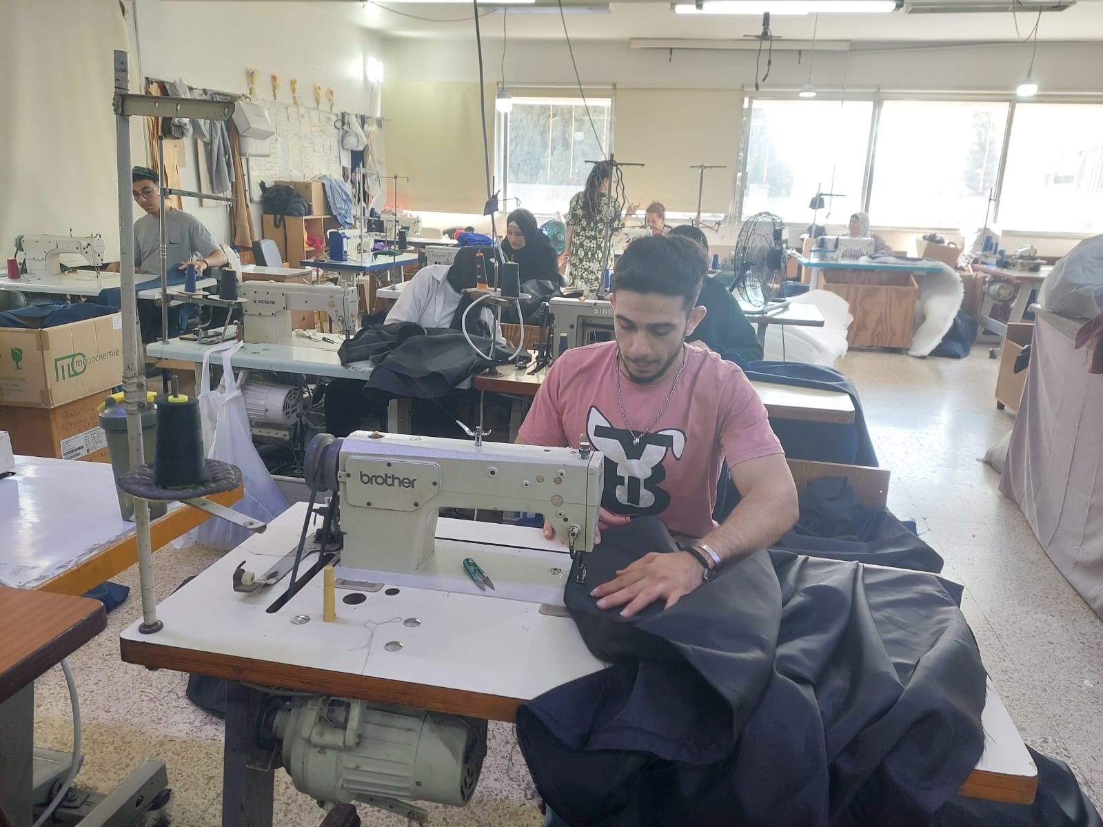 One of Anera's vocational training program participants sews a sleeping bag that will be distributed to someone in need.